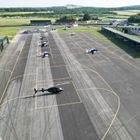 Aircraft parked on the apron at Thruxton Airfield, with the open bay hangar on the right