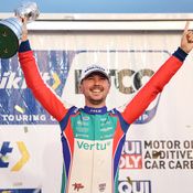 Tom Ingram lifting a trophy