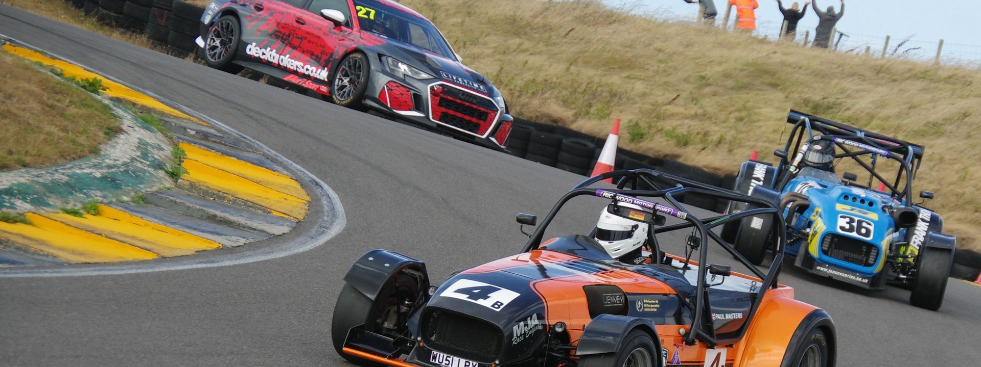 three racing cars on track