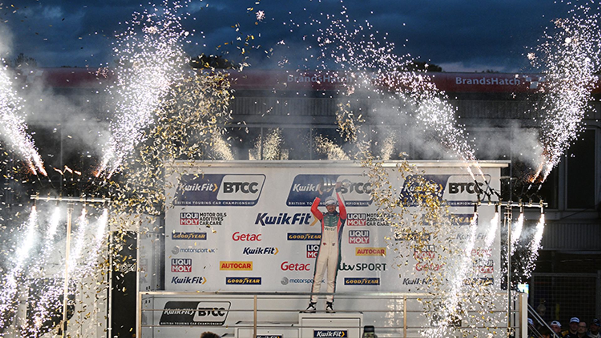 Tom Ingram lifting the BTCC trophy