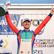 Tom Ingram lifting a trophy