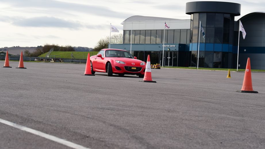 Junior driver driving a Mazda MX-5 