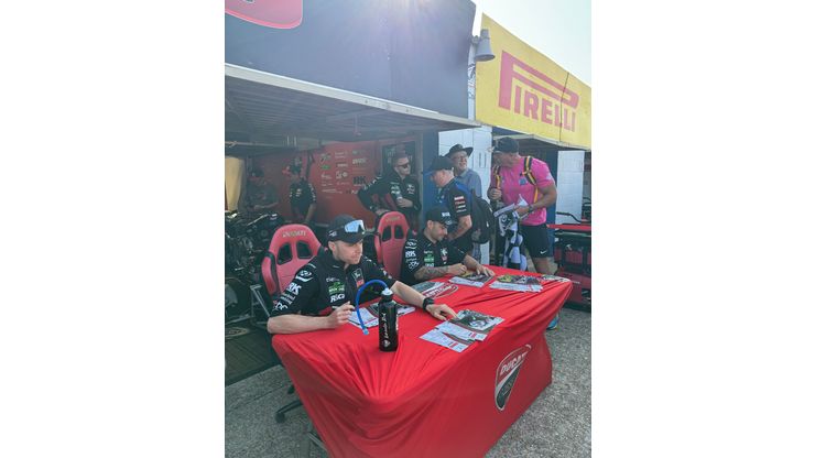 BSB riders signing photos for fans