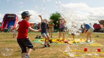 Children playing in the sun with bubbles