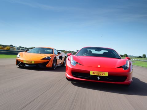 Orange Mclaren and Red Ferrari on track