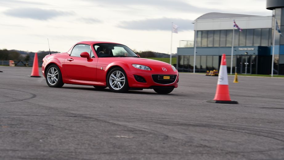 unJunior driver driving a Mazda MX-5 
