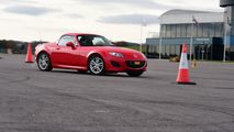 unJunior driver driving a Mazda MX-5
