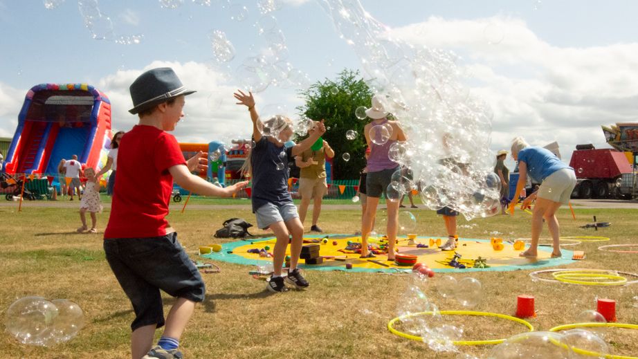 Children playing in the sun with bubbles